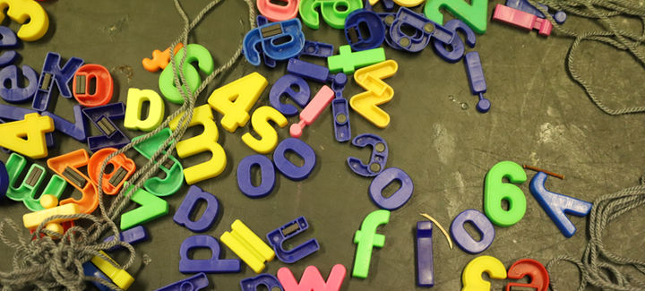 Scattered colorful magnetic letters and numbers