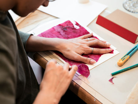 A person tearing a piece of paper.