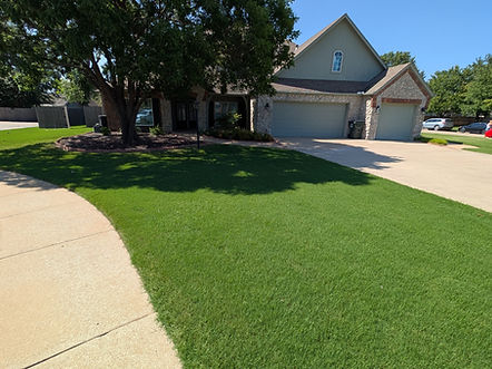 Established Oklahoma lawn receiving professional fertilization and weed control treatment