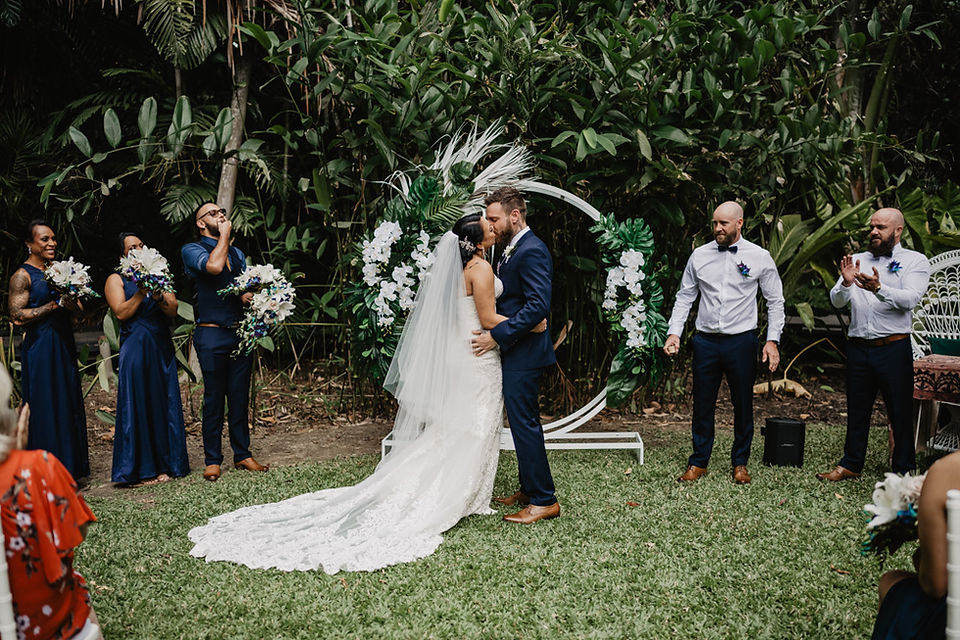 Couples sharing their first kiss at their wedding ceremony in the middle of the Cairns Botanical Gardens.