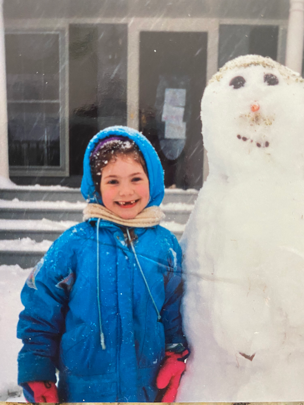 Meggie at 11 years old with a snowman