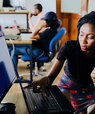 woman and man sitting in front of monito