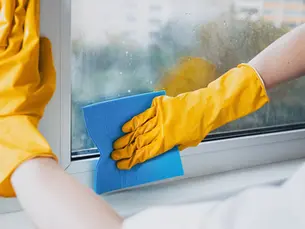 Professional cleaning of window tracks and frames in an Edmonton home