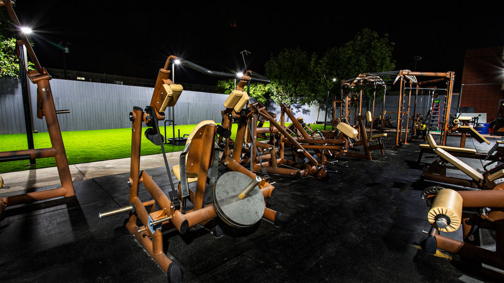 Athlos Iron Lair's unique outdoor strength training rig and equipment under night lights in Torrance Southern California
