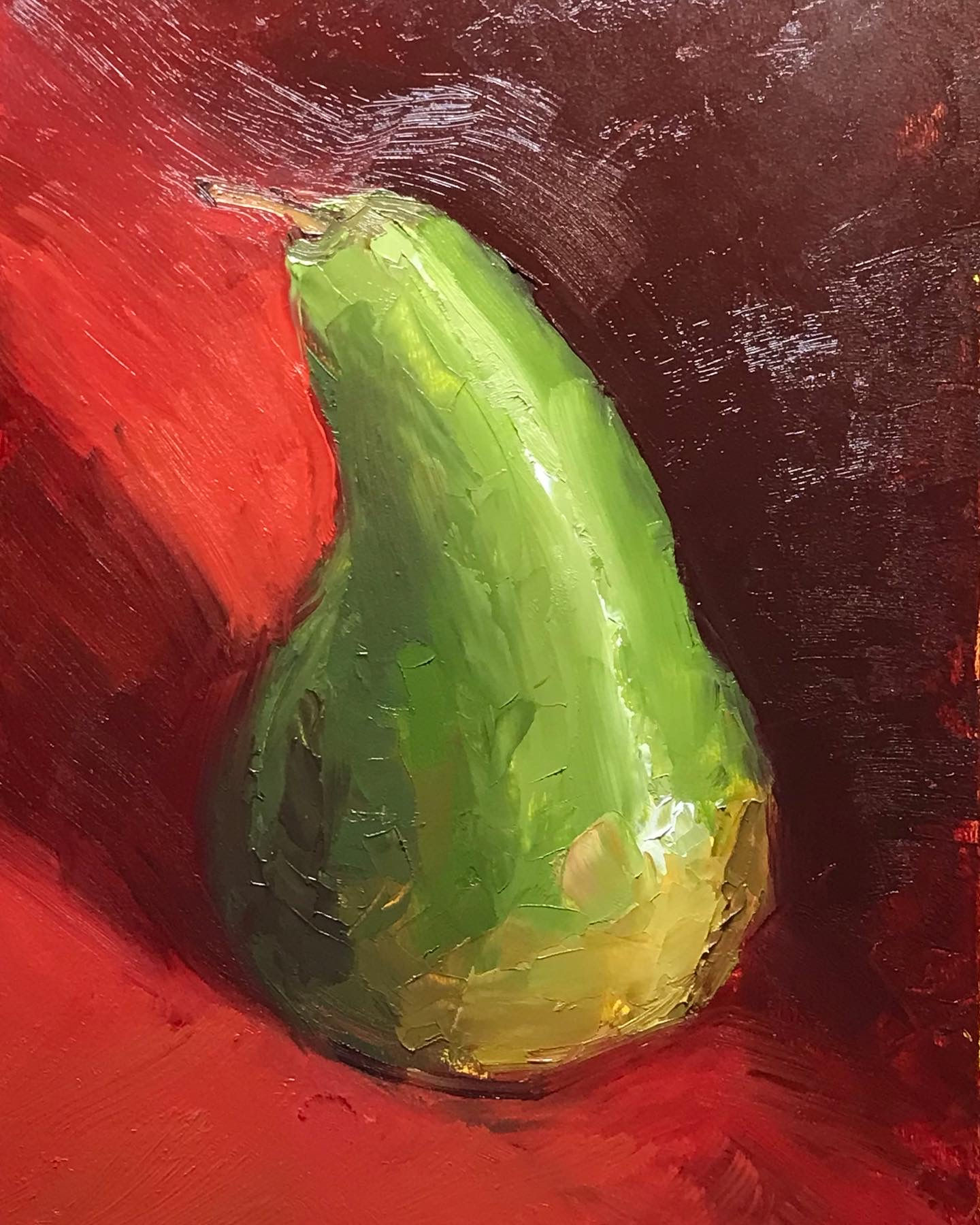 Green pear on red