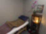 Eye-level view of a cozy acupuncture treatment room with soft lighting