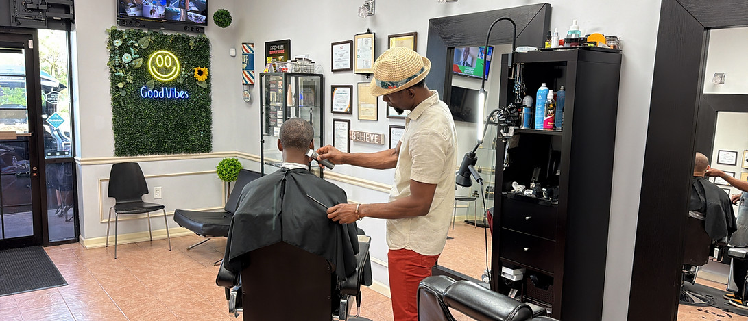 Barber performing precision haircut on client in Lawrenceville GA