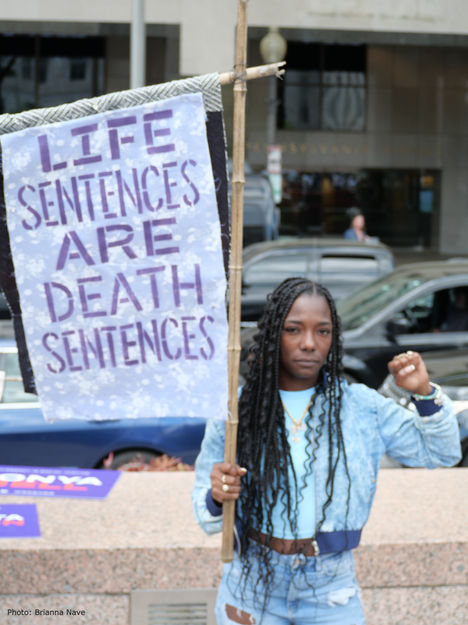 Life sentences are death sentences - woman holding sign