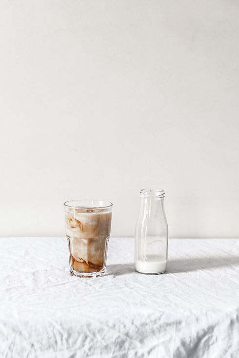white%2520beverage%2520filled%2520clear%2520glass%2520bottle%2520beside%2520brown%2520liquid%2520fil