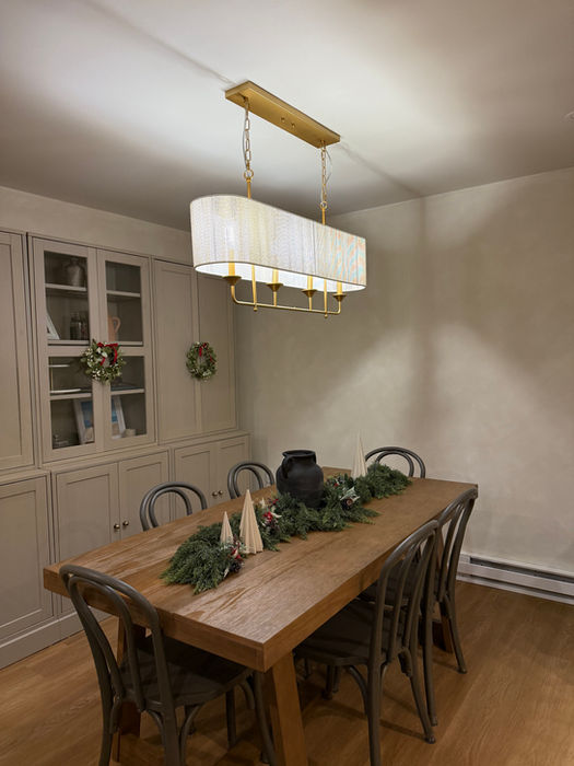 Modern chandelier over a festive wood dining table