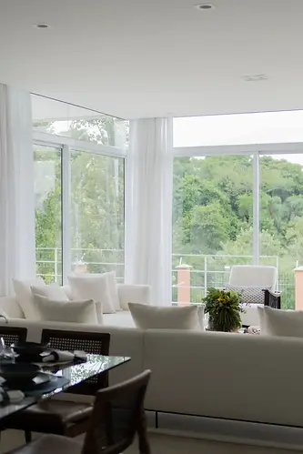 Clean living room looking out into a forested area.
