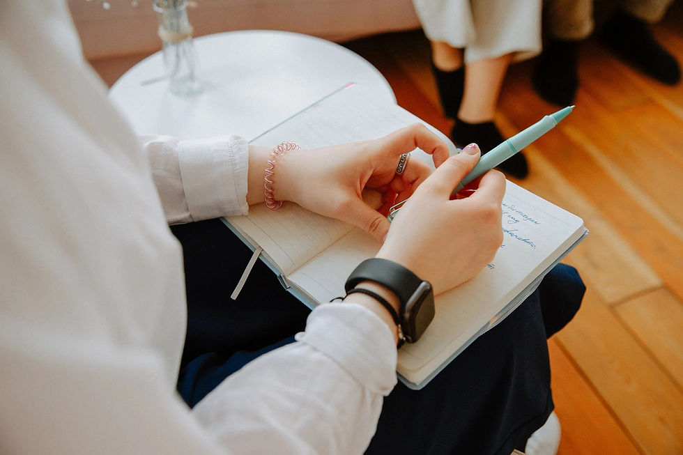 Image of a therapist taking notes in session