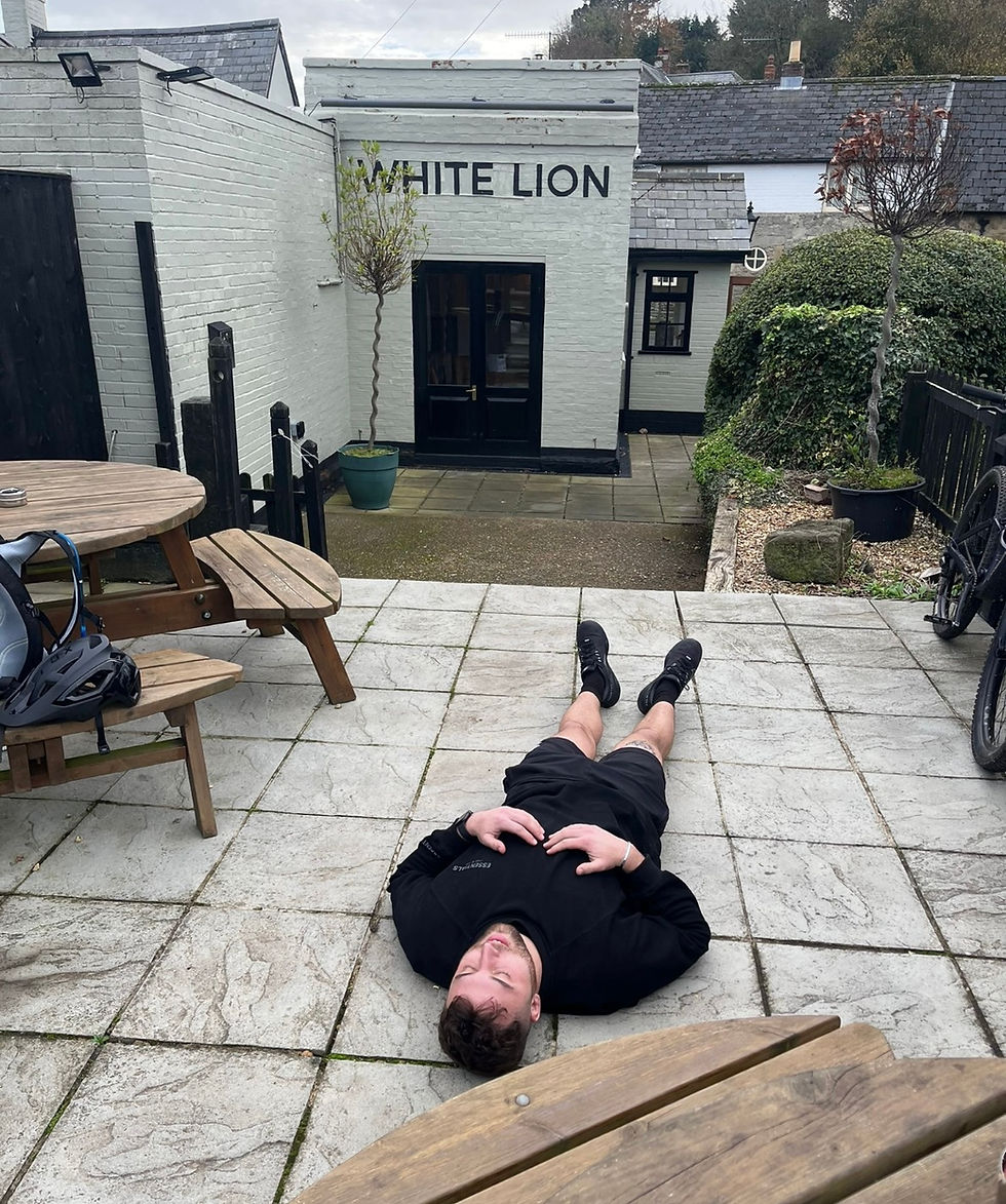 Cyclist laying on the floor exhausted from his long ride