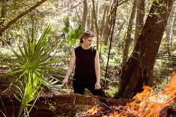 Woman watching a fire burn