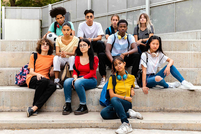 multiracial-teenage-students-sitting-on-steps-look-2025-01-09-15-31-41-utc.jpeg