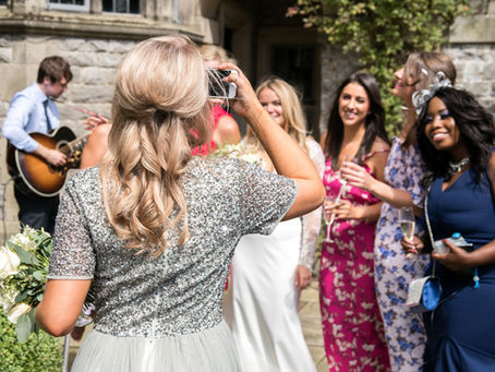 Bridesmaid taking group photo of friends