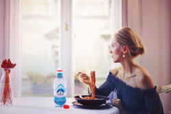 Lindos Woman Sitting on Chair While Eati