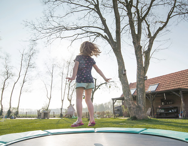 Girl Jumping on Trampoline