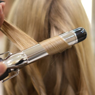 Professional stylist doing a trendy hair cut at Lumiglow Beauty Salon Icon Mall Sanur Bali.