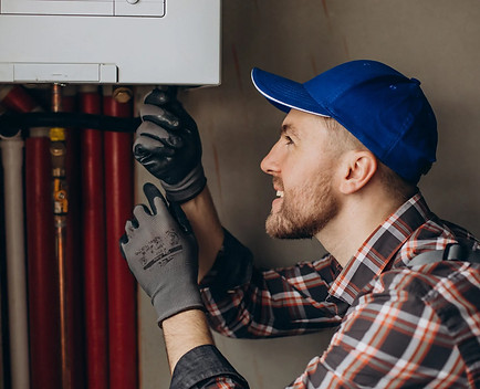 service-man-adjusting-house-heating-system-scaled-1.jpg
