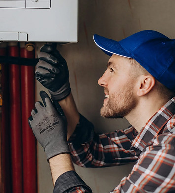 service-man-adjusting-house-heating-system-scaled-1.jpg