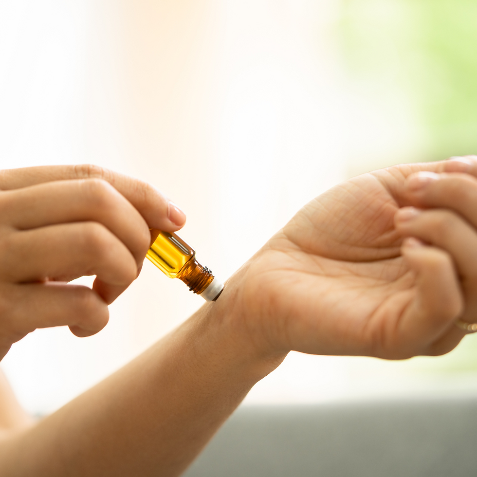 Someone applying aromatherapy roll on to their wrist