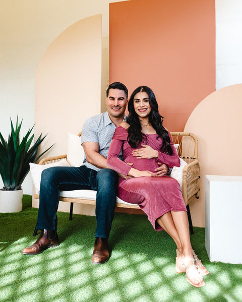 A couple poses for maternity photos