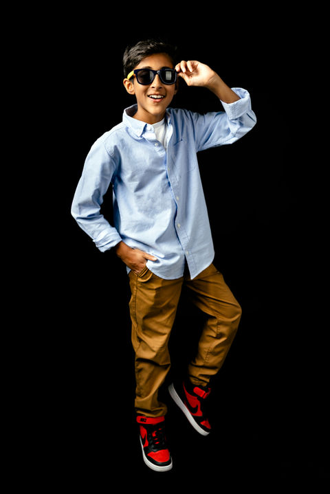 A young boy poses for music branding photos in a photo studio