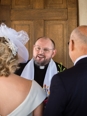 Candid shot of a priest during a wedding ceremony at Chapel Dulcinea in Austin, TX