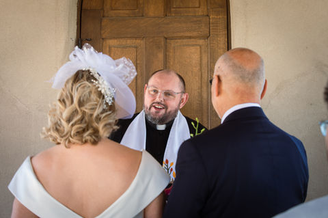 Candid shot of a priest during a wedding ceremony at Chapel Dulcinea in Austin, TX