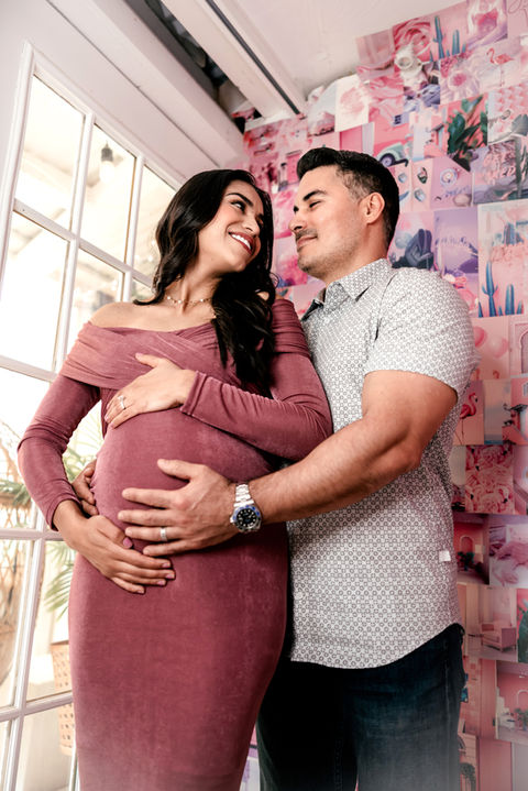 A couple poses for maternity photos