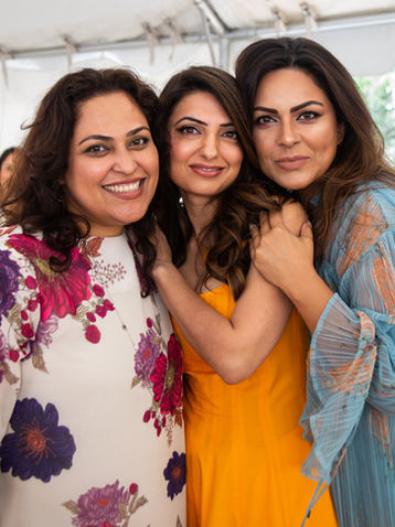 Image of women smiling at an Indian brunch event