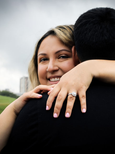 Portrait of an engaged couple hugging outdoors in Austin, TX.