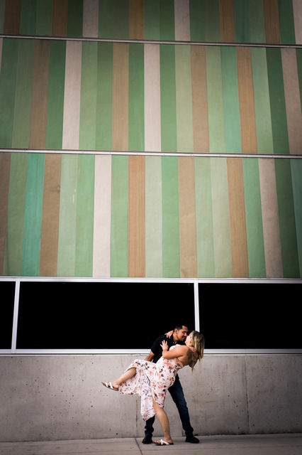 Portrait of an engaged couple kissing in a standing dip position at the long center in Austin, TX