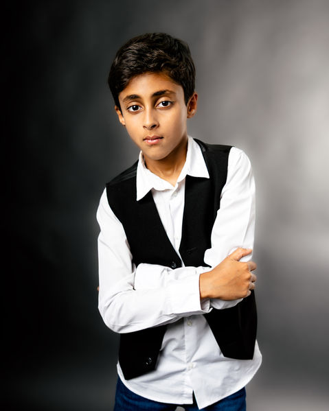 A young boy poses for music branding photos in a photo studio