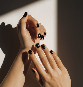 Hands with black nail polish in soft shadow