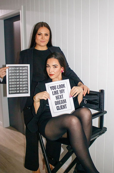 Two women hold signs; one reads 'YOU LOOK LIKE MY NEXT DREAM CLIENT!'