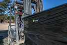 Worker operating a forklift to move a PyroAg pallet.