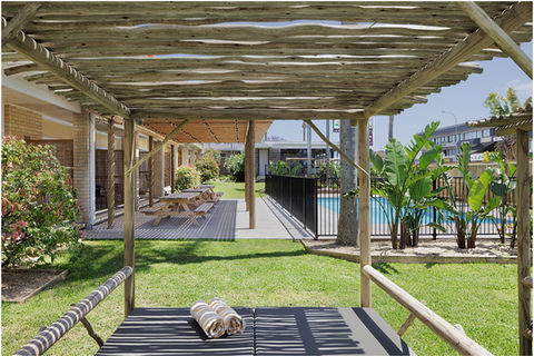 Shaded pool view from daybed at South Pacific Palms Motel