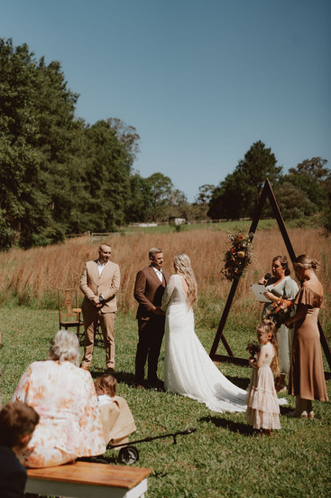 Bride and groom exchanging vows at their outdoor wedding ceremony.