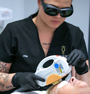 Technician Judge administers facial laser treatment