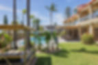 Pool side daybeds picnic tables and gardens.