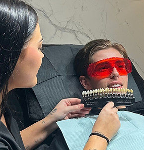 Dental professional matching tooth shade for patient