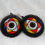 Miniature : Boucles d’oreilles rondes en perles africaines avec dominante noire, entourées de couleurs vives (jaune, rouge, bleu, blanc),