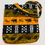 Miniature : Tote bag en wax africain avec des motifs d'éléphants et des symboles tribaux en noir, orange et vert sur fond sombre.