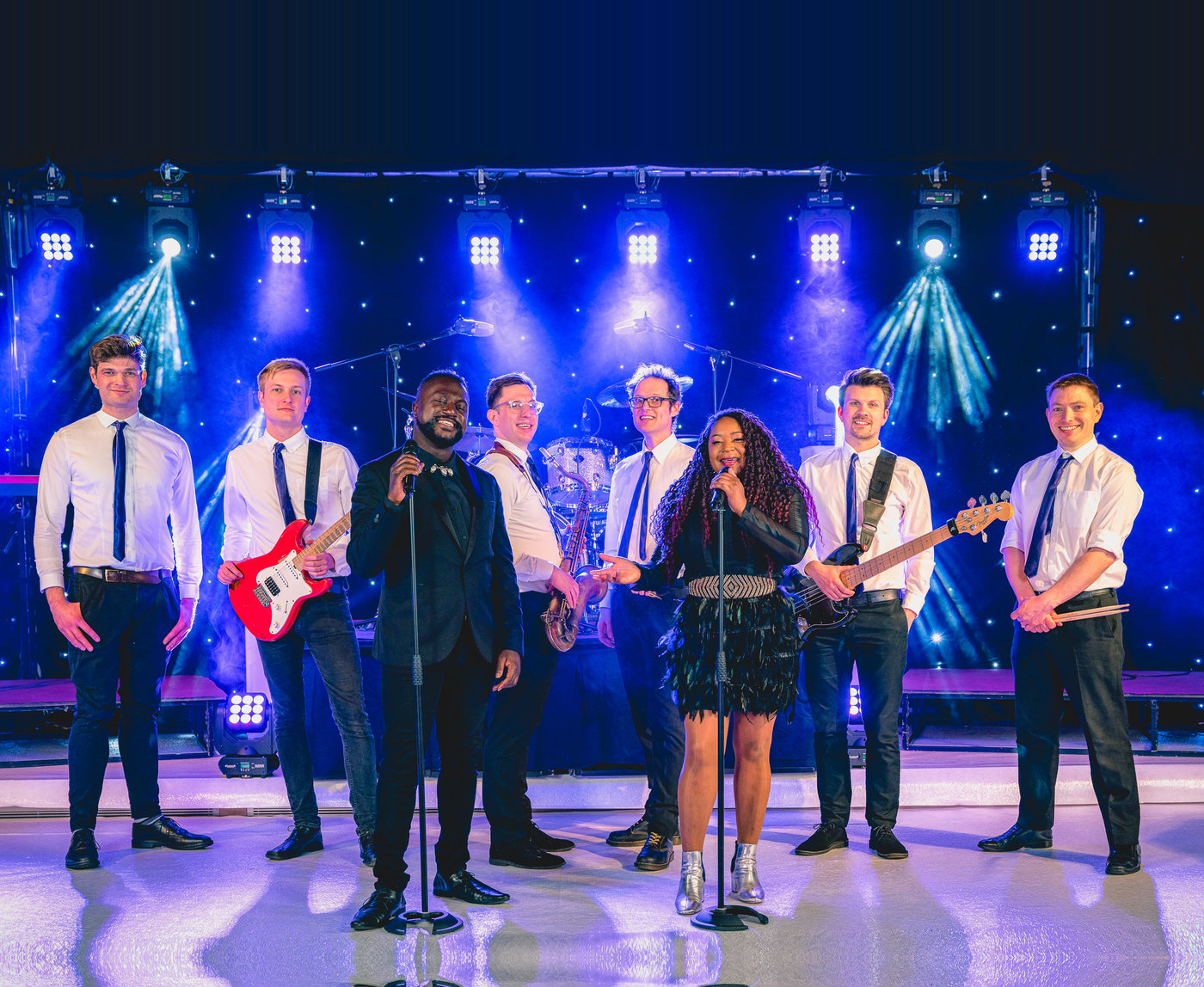 The Diamonds party band with singers and musicians on a brightly lit stage