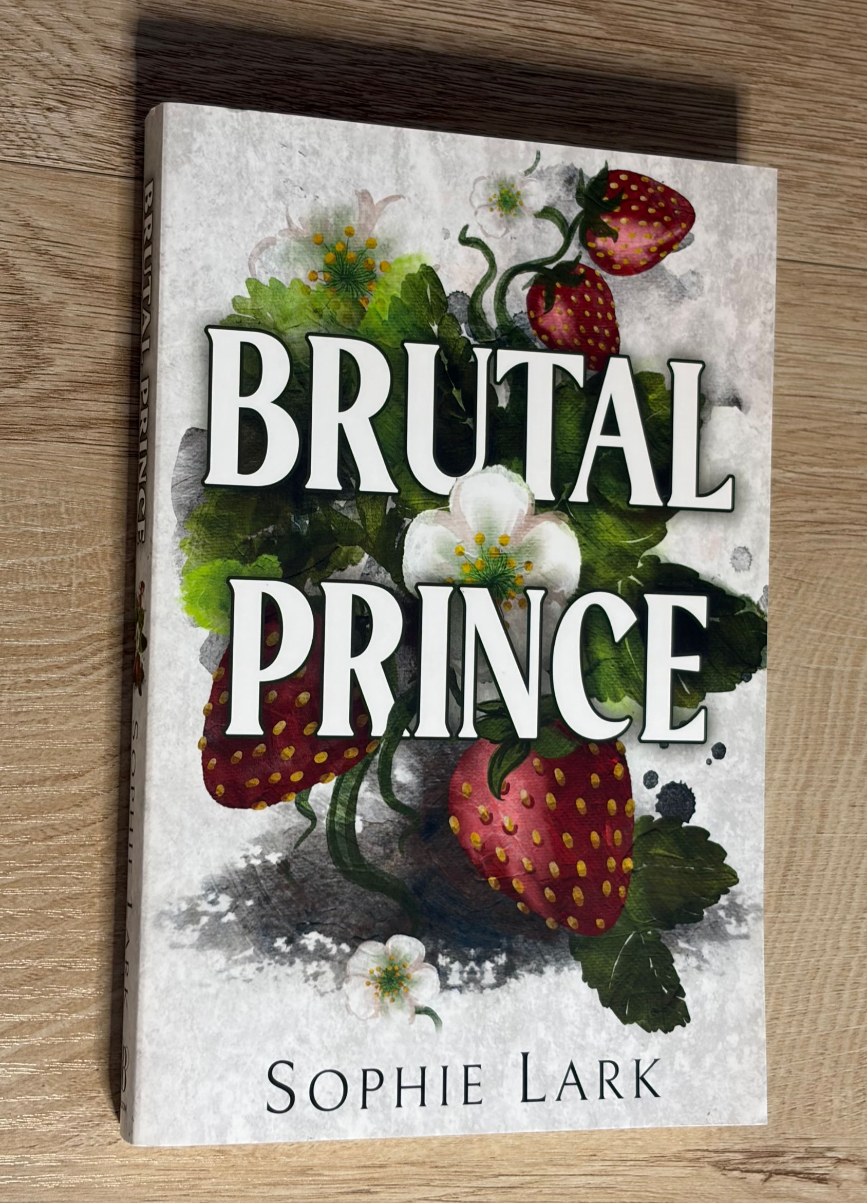 Brutal Prince book cover with strawberries and white flowers