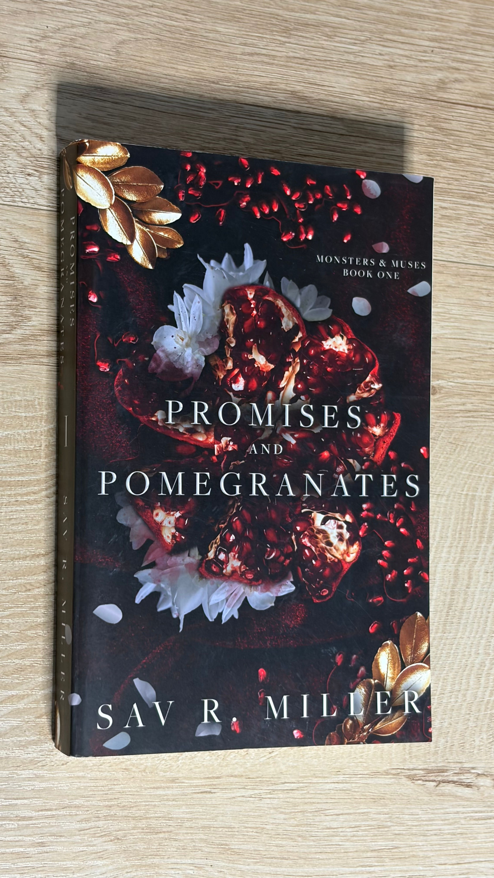 Promises and Pomegranates book cover on a wooden surface