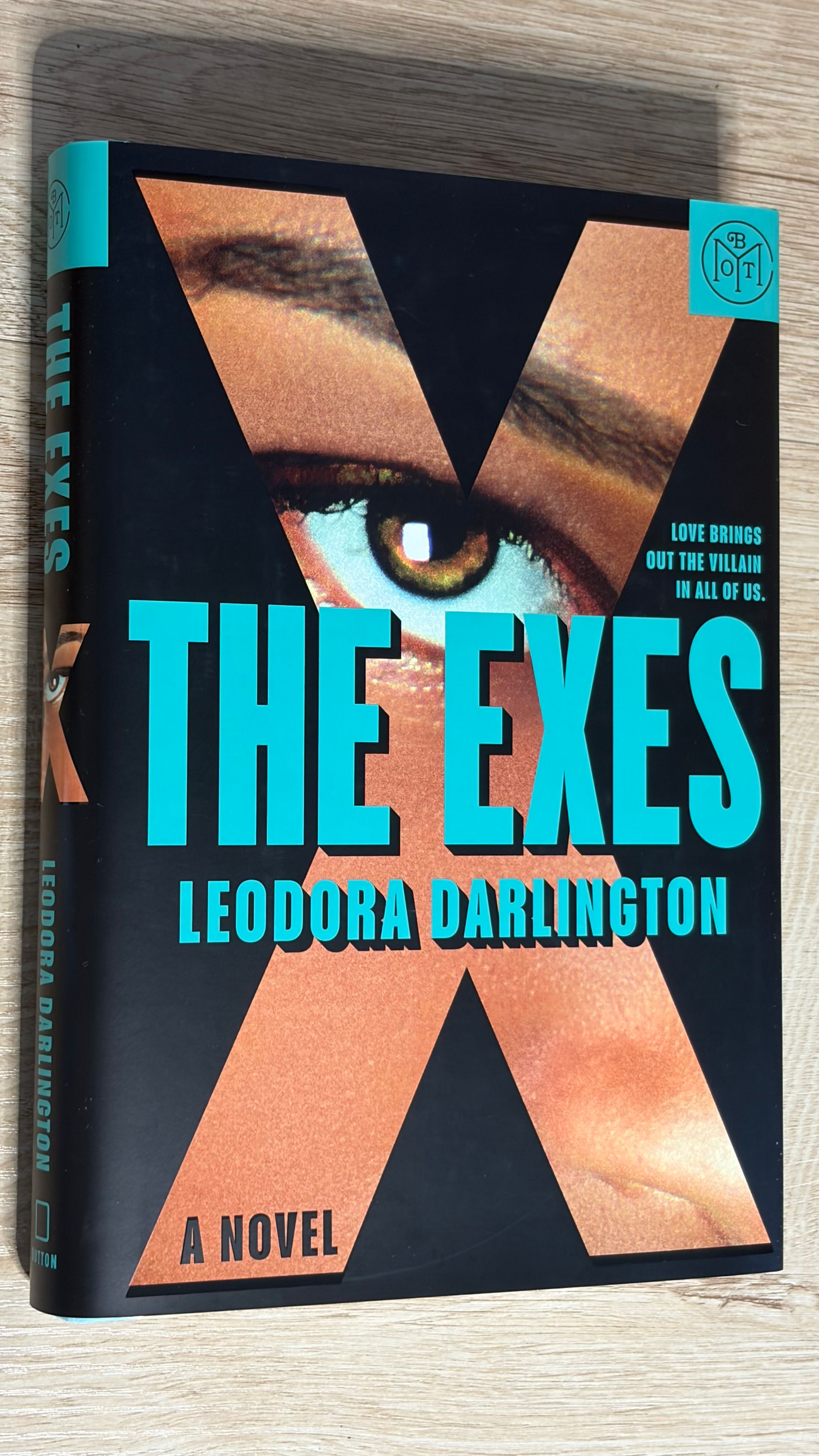 Book cover for The Exes by Leodora Darlington featuring a close-up of an eye behind a large letter X.