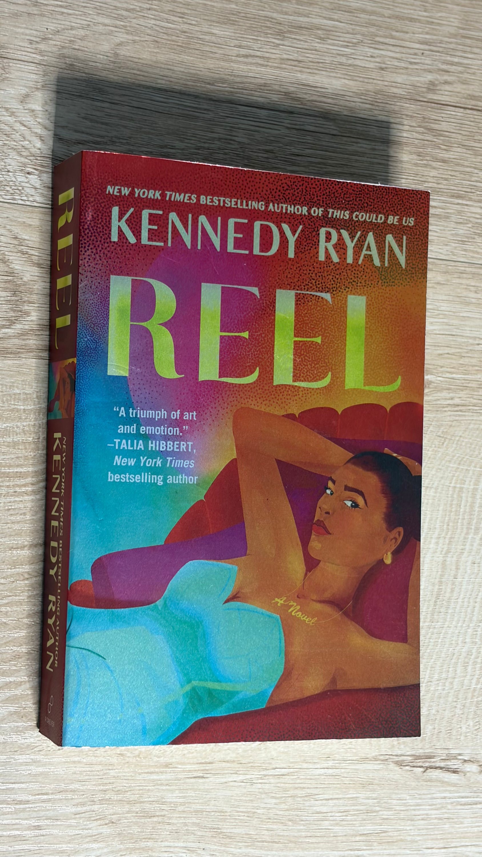 Book cover of Reel by Kennedy Ryan featuring a woman reclining.